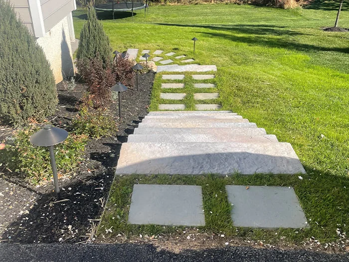 Residential hardscape creation with under deck and subsurface drainage renovation, landscape creation and low voltage lighting addition project in Jamison, PA